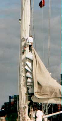 crewman attaching halyard to Velsheda's mainsail